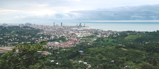 Panorama of the city at the foot of the mountain. Travel in the mountains, holidays in the mountains, hiking