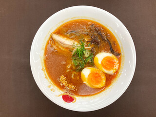 Ramen is a Japanese noodle dish. It consists of Chinese-style wheat noodles served in a broth; common flavors are soy sauce and miso, with typical toppings including sliced pork, nori, and scallions.