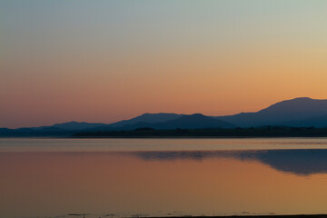 Lake at sunset blue hour. Wetland and Mountain landscape.