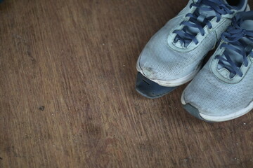 Broken blue shoes on the floor 