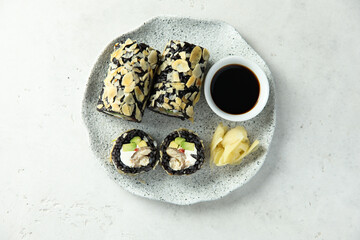 Black rice sushi rolls with almond and eel