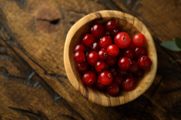 Fresh ripe cranberry in a wooden bowl