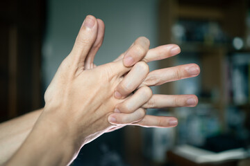 A man doing a knuckle cracking