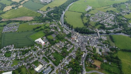 Beautiful aerial view of the river flowing through Thomastown, County Kilkenny, Ireland - obrazy, fototapety, plakaty