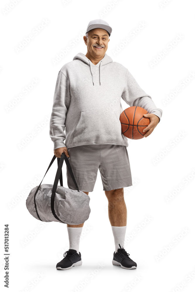 Poster Full length portrait of a mature man with a basketball and a sports bag