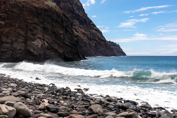 Scenic view on pebble beach Playa del Tamadite in Anaga mountains, Tenerife, Canary Islands, Spain, Europe. Panoramic coastal hiking trail from Afur to Taganana. Waves from Atlantic Ocean. Seascape