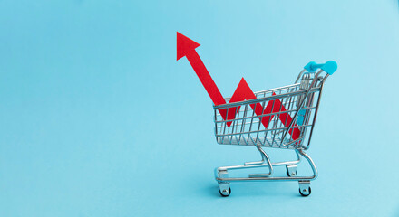 Rising cost of shopping. Shopping cart with red inflation arrow - obrazy, fototapety, plakaty