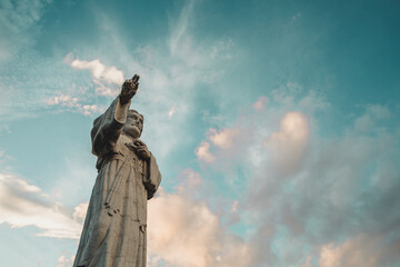The statue of Jesus (Cristo de La Misericordia) on a blue colorful sky in Nicaragua San juan del sur