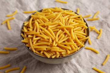 Dry Organic Maccheroni Pasta in a Bowl, side view.
