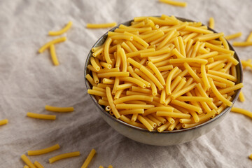 Dry Organic Maccheroni Pasta in a Bowl, side view.