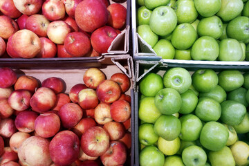 Red and green apples on  shop window close-up.