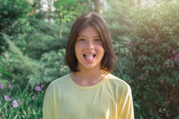 Portrait of a cheerful playful young girl who shows her tongue.