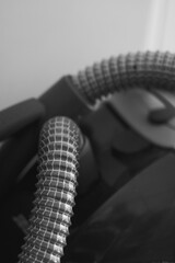Closeup grayscale shot of vacuum cleaner machine hoses