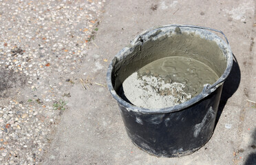 Bucket full of concrete. House renovating concept. 