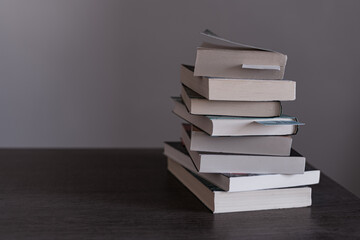 Pile of books ready to be read or that have been read on Book Day  on top of a wooden table