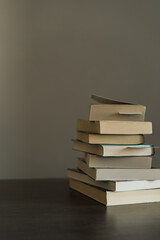 Pile of books ready to be read or that have been read on Book Day  on top of a wooden table
