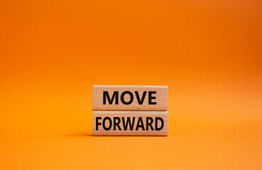 Move forward symbol. Wooden blocks with words Move forward. Beautiful orange background. Business and Move forward concept. Copy space.