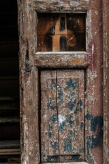 an old peeled wooden door with a light and dark brown insert can be used as a vertical background