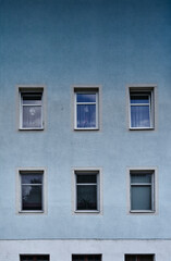 Minimalist house facade with windows and a blue color gradient