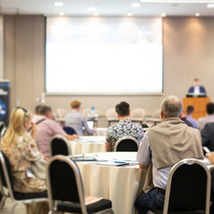 Business speaker giving a talk at business conference event.