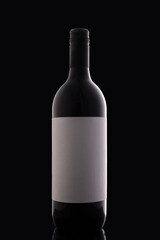 Bottle of red wine isolated on black