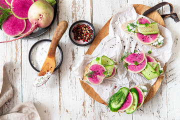 Healthy breakfast bruschetta from sliced watermelon radish and cottage cheese	