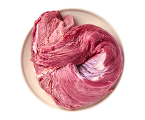 Rolled raw beef tenderloin on plate isolated on white background, top view