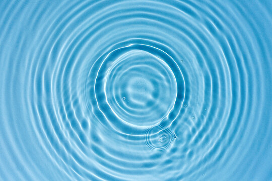 Abstract background, blue water texture with round ripples, close up