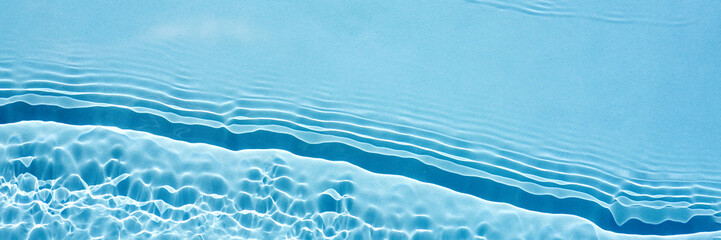 Background, texture of transparent blue water with seething ripples , waves