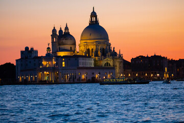 Stunning view of the Venice skyline with the Grand Canal and Basilica Santa Maria Della Salute in the distance during a dramatic sunrise. Picture taken from Ponte Dell’ Accademia.