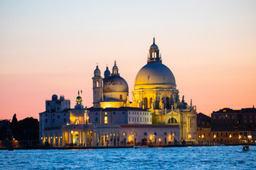 Stunning view of the Venice skyline with the Grand Canal and Basilica Santa Maria Della Salute in the distance during a dramatic sunrise. Picture taken from Ponte Dell’ Accademia. - obrazy, fototapety, plakaty