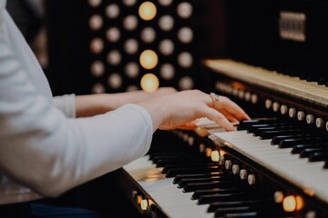Female playing a piano with multiple keyboards