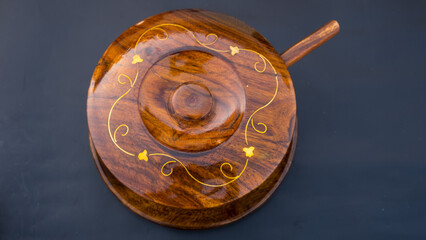 Wooden bowl with sugar on blue background.