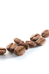Roasted coffee beans isolated close up on white background, clipping path