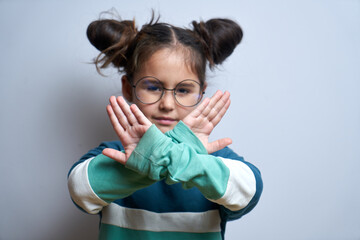 Say no to child abuse. Little girl showing stop gesture isolated on white background - obrazy, fototapety, plakaty