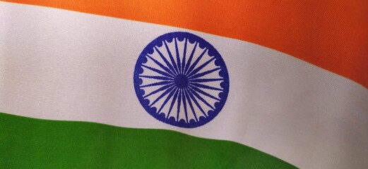 Tricolor official flag of india. august 15 independence and january 26 republic day festival concept. Blue ashoka chakra symbol between green and saffron color. Closeup horizontal view with copy space