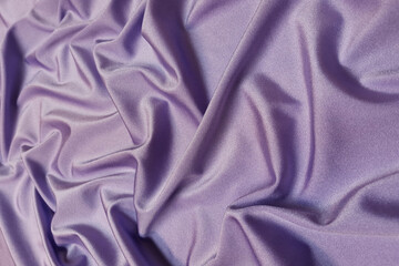 Purple supplex crumpled or wavy fabric texture background. Abstract linen cloth soft waves. Silk fabric. Smooth elegant luxury cloth texture. Concept for banner or advertisement.