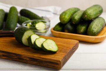 Fresh organic cucumbers on a white wooden table.Cucumber slices. Salad ingredient. Fresh vegetables. Vegan food. Healthy food. Fresh organic vegetables.