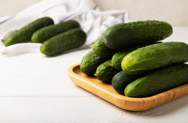 Fresh organic cucumbers on a white wooden table.Cucumber slices. Salad ingredient. Fresh vegetables. Vegan food. Healthy food. Fresh organic vegetables.