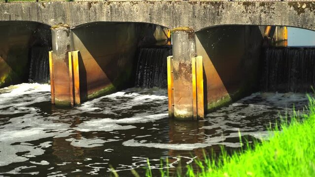 Water coming out of a sluice in summer