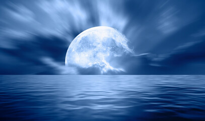 Night sky with blue moon in the clouds over the calm blue sea "Elements of this image furnished by NASA"