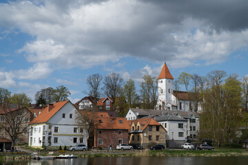 Fototapeta premium Talsi, Latvia - 6 May 2022: Talsi Old Town, the town promenade and the church in spring with sky and clouds.
