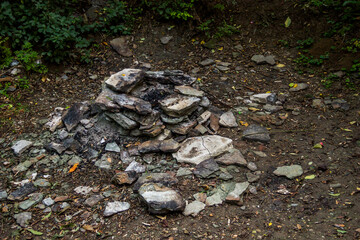 stones and ashes at fireplace in the forest