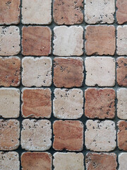 The stone floor is made of two-color tiles in a checkerboard pattern. View from above