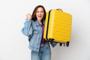 Young caucasian woman isolated on white background in vacation with travel suitcase