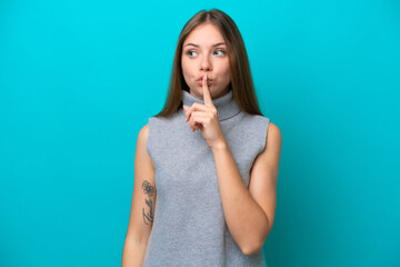 Young Lithuanian woman isolated on blue background showing a sign of silence gesture putting finger in mouth