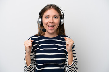 Telemarketer caucasian woman working with a headset isolated on white background celebrating a victory in winner position