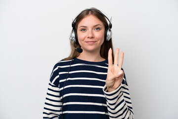 Telemarketer caucasian woman working with a headset isolated on white background happy and counting three with fingers