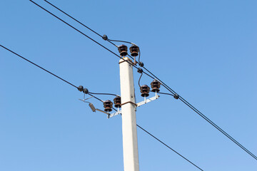 power line summer landscape, passing overhead electricity wire of the support carrying the light