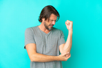 Senior dutch man isolated on blue background with pain in elbow